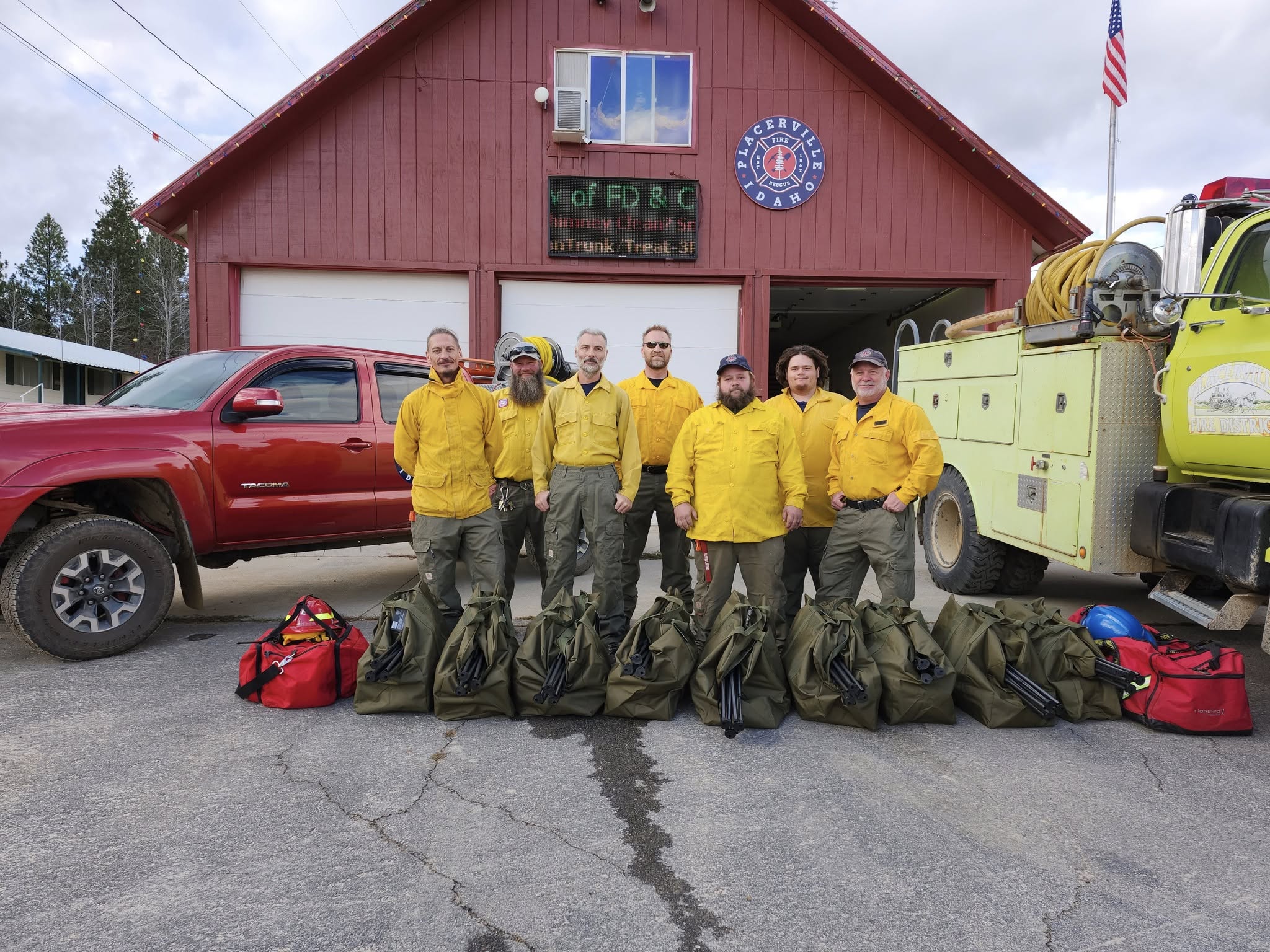 firefighters in front of Station One Placerville with donated equipment bags